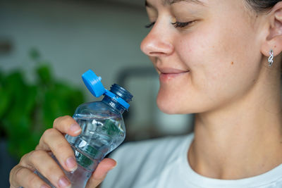 Close-up of woman drinking water