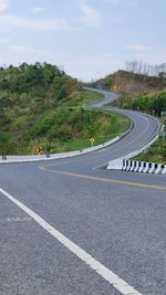 Road by mountain against sky