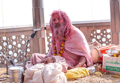 Midsection of man sitting in a traditional clothing