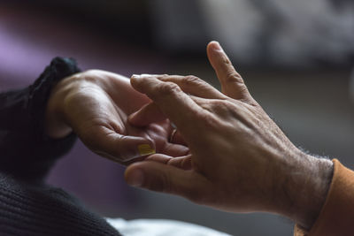 Cropped image of man holding hands