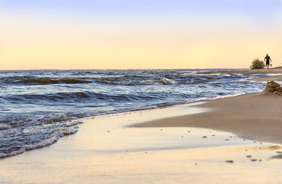 Scenic view of sea against clear sky during sunset