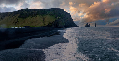 Iceland black sand beach with huge waves at reynisfjara vik.