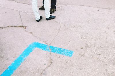 Low section of man standing on footpath