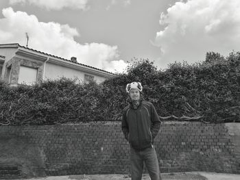 Portrait of man standing against sky