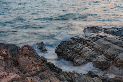 Scenic view of rocks on sea shore