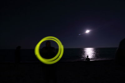 Scenic view of sea against sky at night