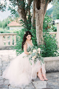 Portrait of young woman standing in park