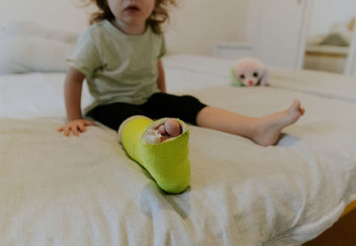 Green plaster on the leg of a little girl.