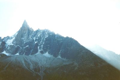 Scenic view of mountains against cloudy sky