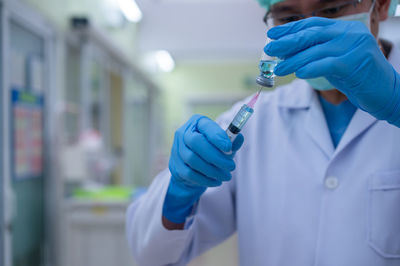 Rear view of people holding umbrella