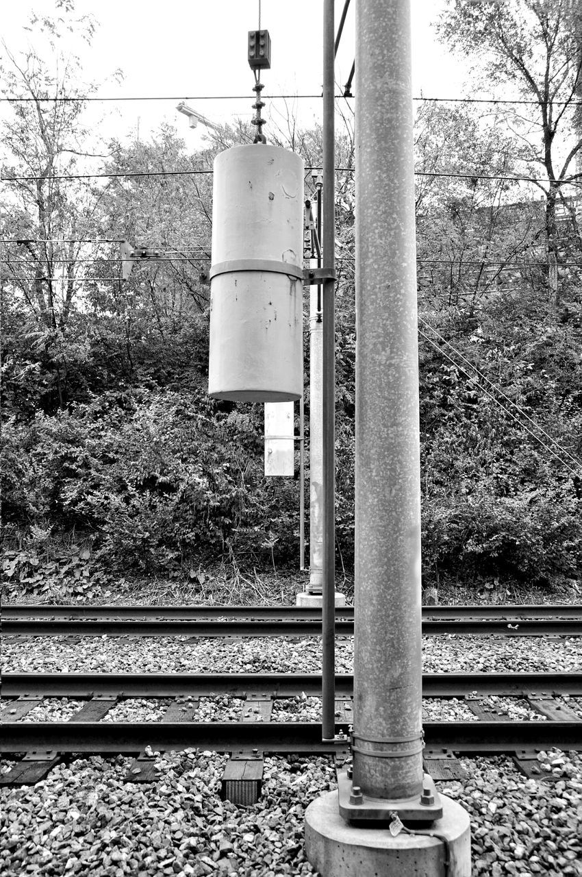 tree, metal, metallic, no people, growth, day, pole, outdoors, plant, railroad track, connection, built structure, close-up, field, pipe - tube, sunlight, sky, safety, fence, electricity