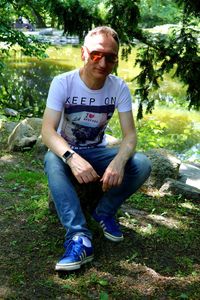 Full length of young man sitting in park