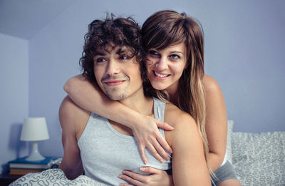 Portrait of young couple sitting at home