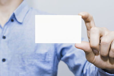 Midsection of person holding mobile phone