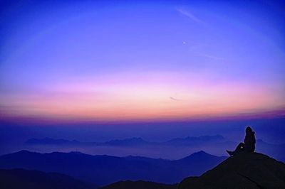 Scenic view of mountains against sky at sunset