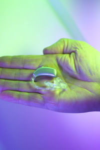 Close-up of human hand against blue background