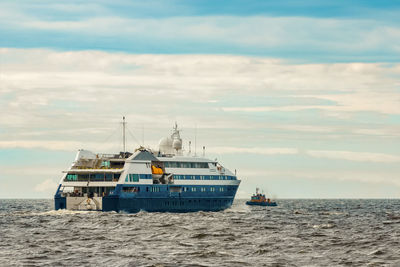 Ship sailing on sea against sky