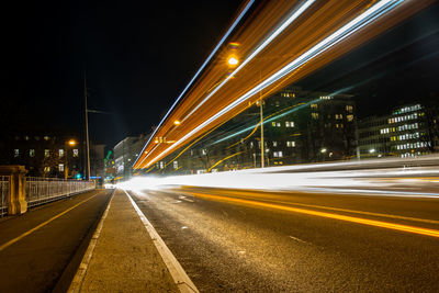 Light trails on road in city at night