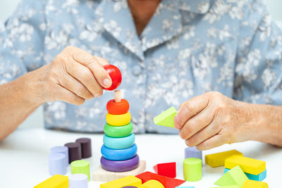 Midsection of man playing with toy blocks