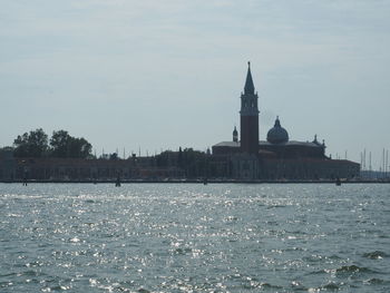 View of building by sea against sky