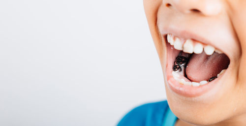 Close-up of woman against white background