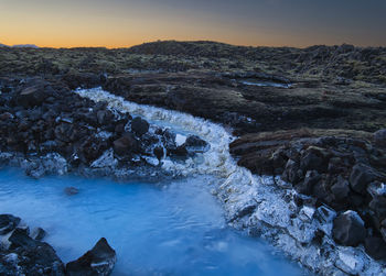 Scenic view of river against sky during sunset