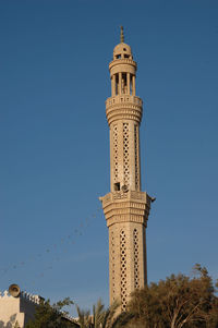 Low angle view of historical building against clear blue sky