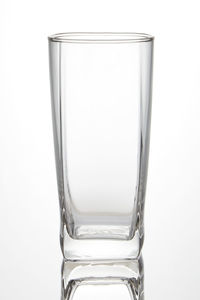 Close-up of empty glass against white background
