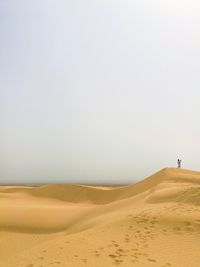 Scenic view of desert against clear sky