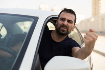 Portrait of man sitting in car