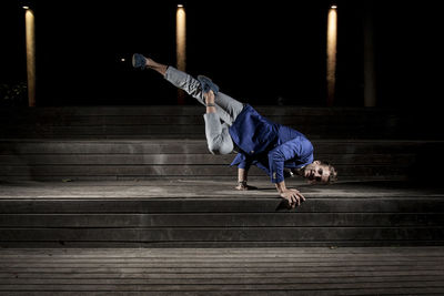 Man breakdancing on steps