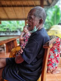 Man holding while sitting on seat