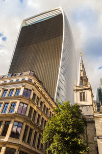 Low angle view of building against cloudy sky