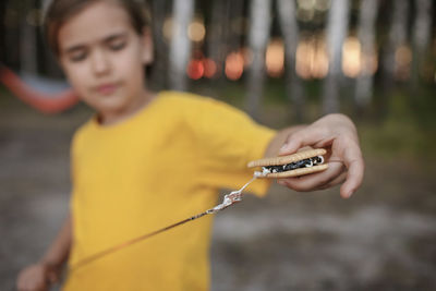 Close-up of woman holding hands playing outdoors