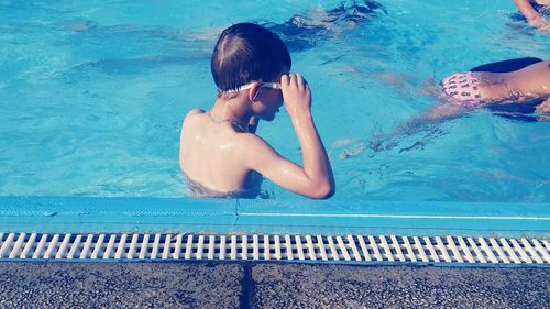 Rear view of boy in swimming pool