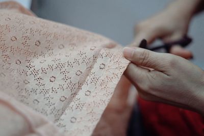 Cropped image of woman cutting fabric