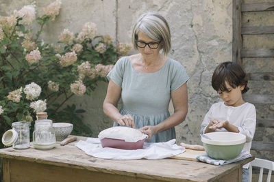 Woman and girl having food on table