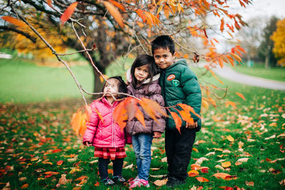 Full length of a girl with autumn leaves