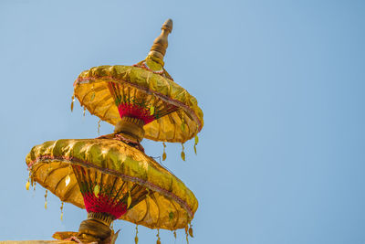 Low angle view of yellow leaf against clear sky