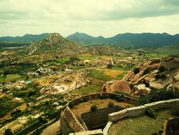 Aerial view of landscape against cloudy sky