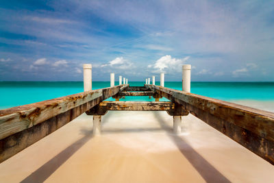 Lifeguard hut on beach against sky