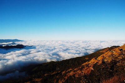 Scenic view of mountains against blue sky