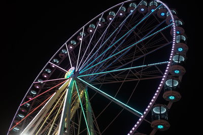 Low angle view of ferris wheel against sky at night