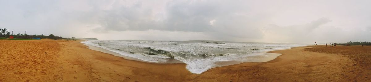 Scenic view of sea against cloudy sky