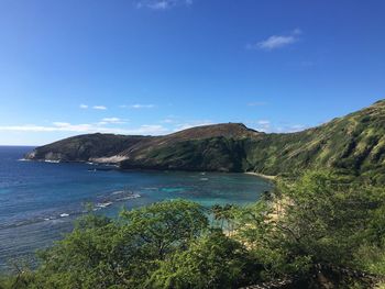 Scenic view of sea and mountains against sky