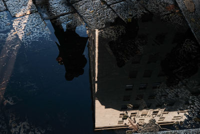 Reflection of building in puddle