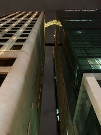 Low angle view of modern buildings in city at night