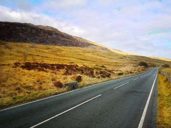 Empty road against sky