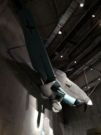 Low angle view of illuminated airplane on ceiling