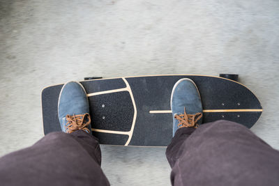 Low section of man standing on skateboard